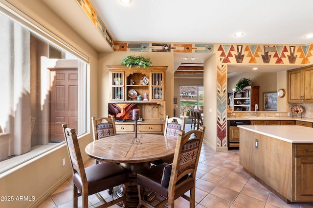 dining area with light tile patterned flooring and sink