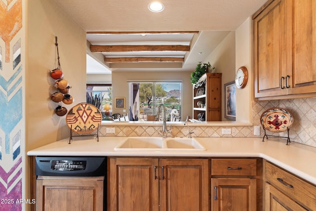 kitchen with dishwasher, sink, and backsplash