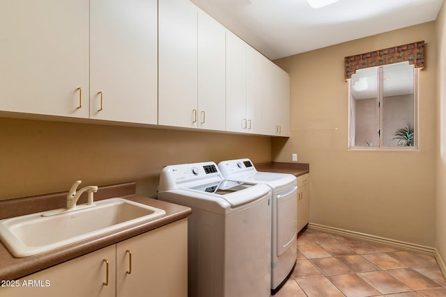 laundry area with washer and dryer, sink, cabinets, and light tile patterned flooring