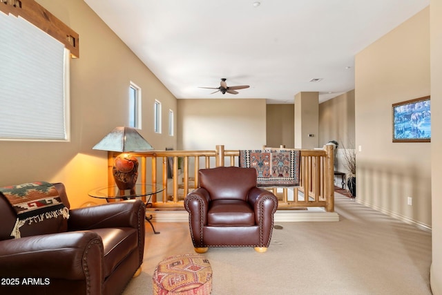 carpeted living room with ceiling fan