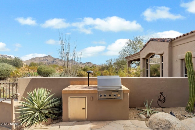 view of patio featuring area for grilling and a mountain view