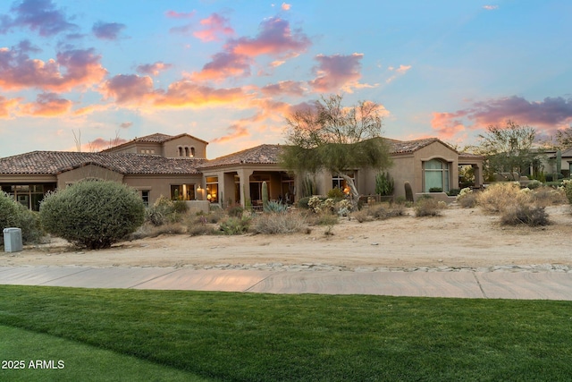 mediterranean / spanish-style house with a yard