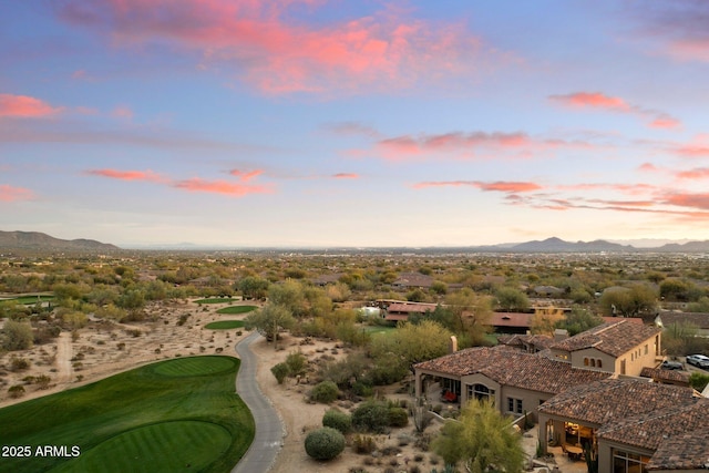 aerial view at dusk featuring a mountain view