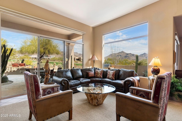 living room with a mountain view and light tile patterned floors