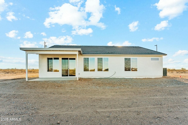 back of property with a patio and stucco siding