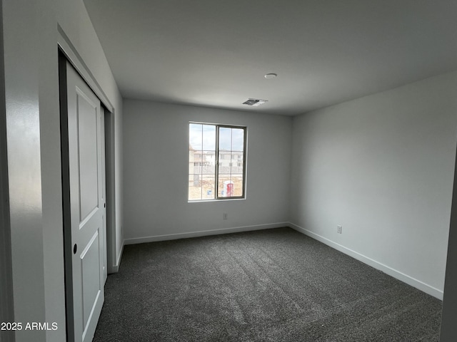 17481 W Fulton St, Goodyear, AZ 85338 - unfurnished bedroom with dark carpet, baseboards, and a closet
