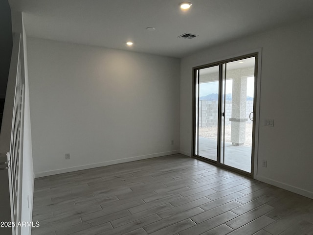 17481 W Fulton St, Goodyear, AZ 85338 - unfurnished room with wood finished floors, baseboards, and recessed lighting