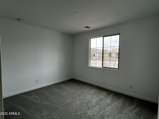 17481 W Fulton St, Goodyear, AZ 85338 - unfurnished room featuring dark carpet, baseboards, and a smoke detector