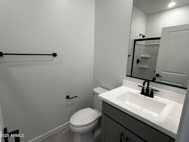 17481 W Fulton St, Goodyear, AZ 85338 - full bath with vanity, toilet, baseboards, a shower, and marble look tiles