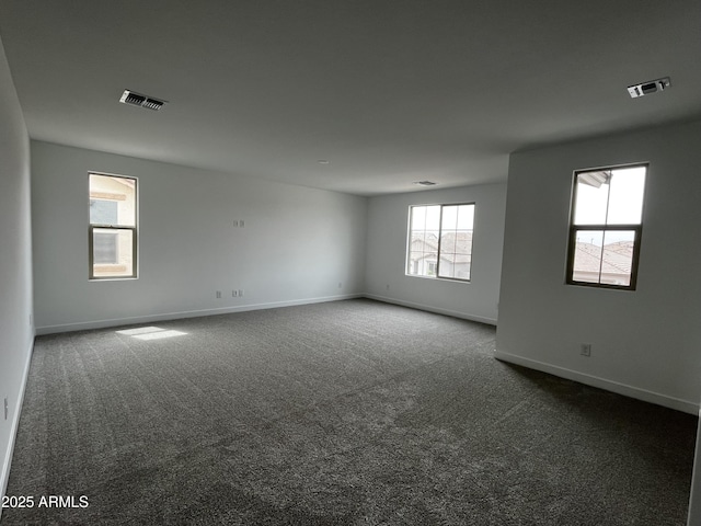 17481 W Fulton St, Goodyear, AZ 85338 - spare room featuring dark colored carpet and baseboards