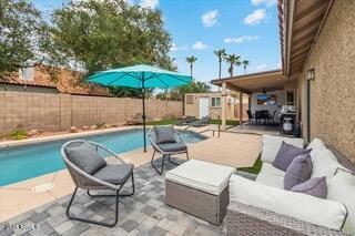 view of swimming pool with an outdoor living space, an outdoor structure, and a patio area