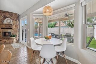 dining space featuring hardwood / wood-style flooring and a fireplace