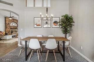 dining space with ceiling fan with notable chandelier