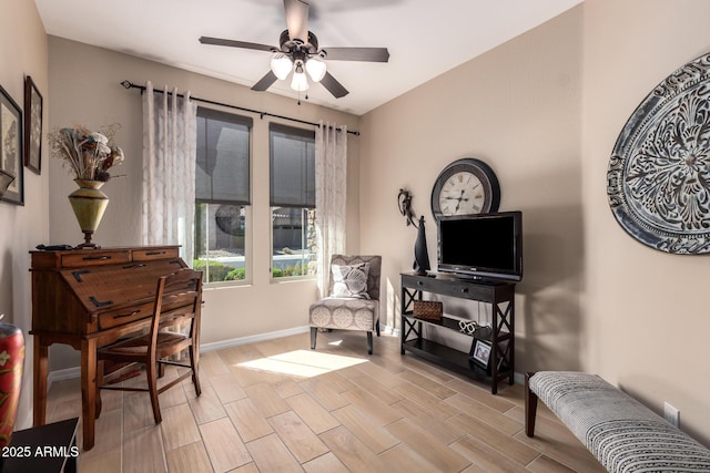 living area with wood finish floors, baseboards, and ceiling fan