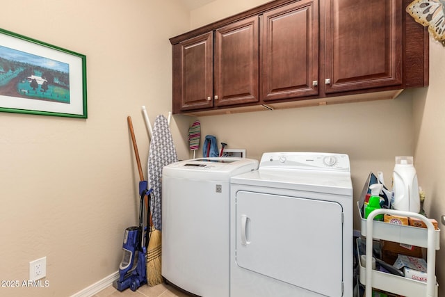 laundry area with cabinet space, washer and dryer, and baseboards