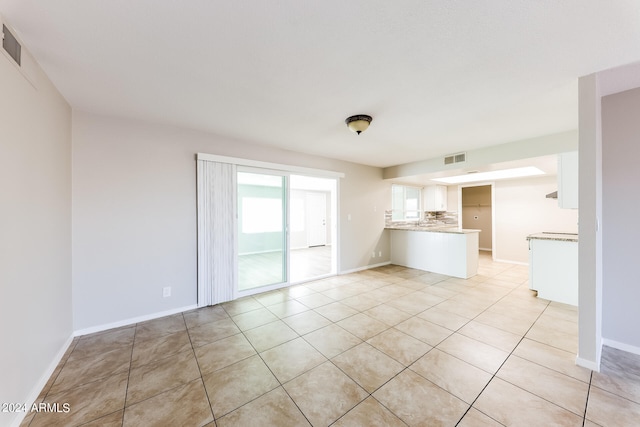 unfurnished living room featuring light tile patterned floors