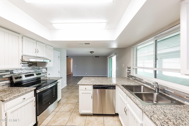 kitchen featuring white cabinets, stainless steel appliances, ventilation hood, and light tile patterned floors