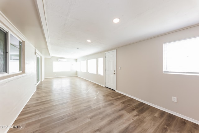 spare room with wood-type flooring and plenty of natural light