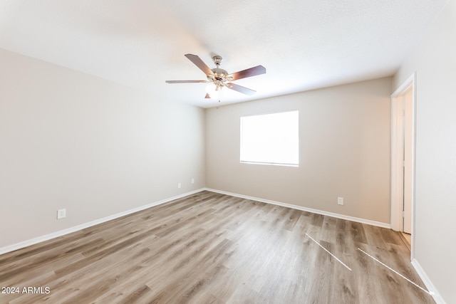 empty room featuring light wood-type flooring and ceiling fan