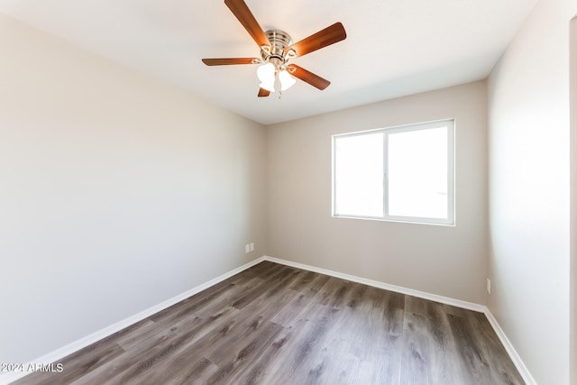 unfurnished room with hardwood / wood-style flooring and ceiling fan