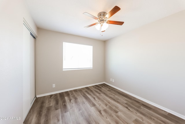 unfurnished room with hardwood / wood-style floors and ceiling fan