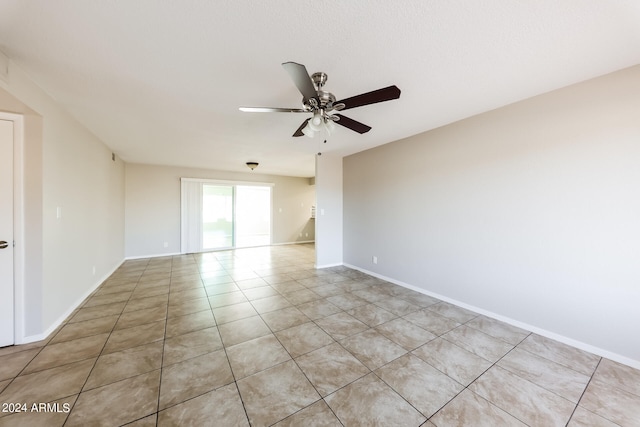 empty room featuring ceiling fan and light tile patterned floors