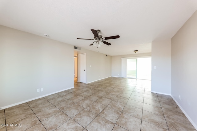 unfurnished room featuring light tile patterned flooring and ceiling fan