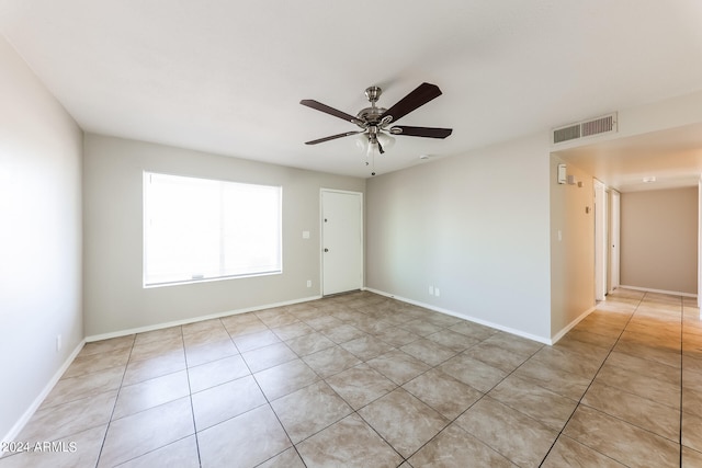 unfurnished room with ceiling fan and light tile patterned floors