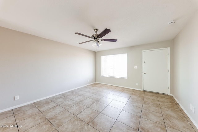 unfurnished room featuring light tile patterned floors and ceiling fan