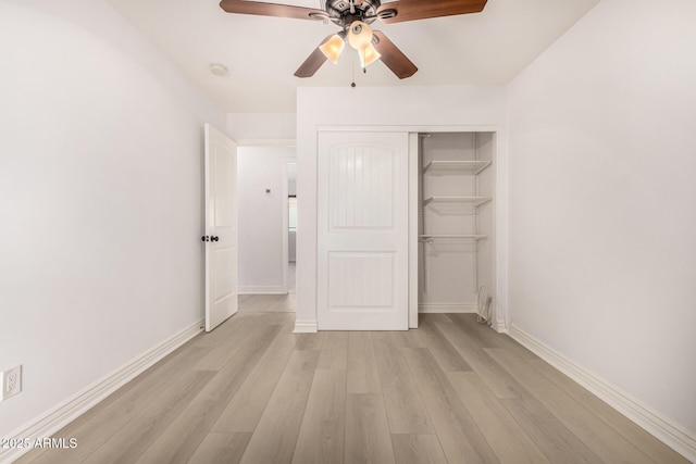 unfurnished bedroom featuring light wood-type flooring, a closet, and ceiling fan