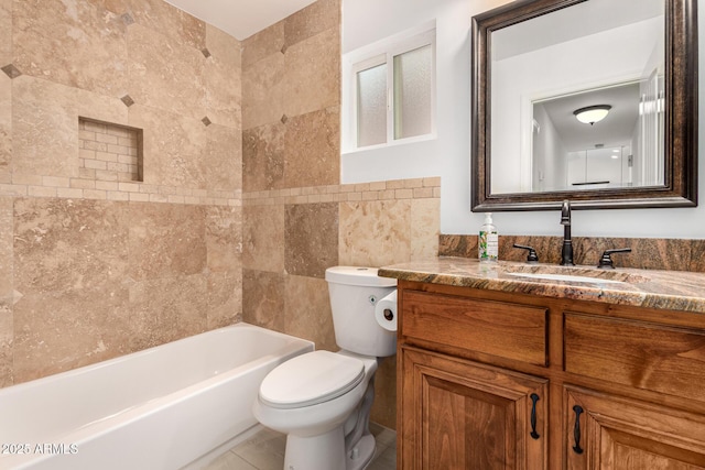 bathroom with tile patterned flooring, vanity, toilet, and tile walls