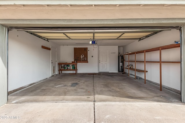 garage featuring electric water heater and a garage door opener