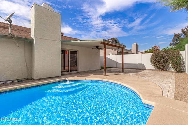 view of pool with ceiling fan and a patio