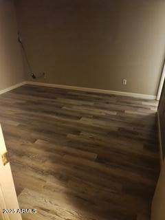 spare room with dark wood-type flooring