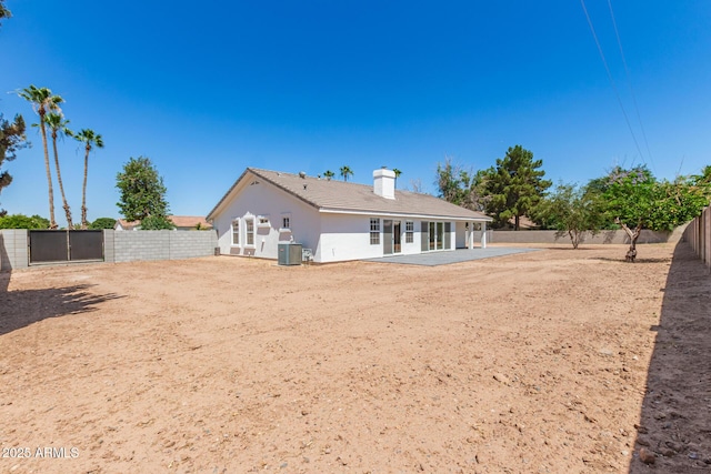 1513 S 108th Way, Chandler, AZ 85286 - back of property with cooling unit, a patio, a fenced backyard, a chimney, and stucco siding
