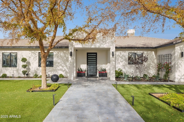 ranch-style home with a front lawn