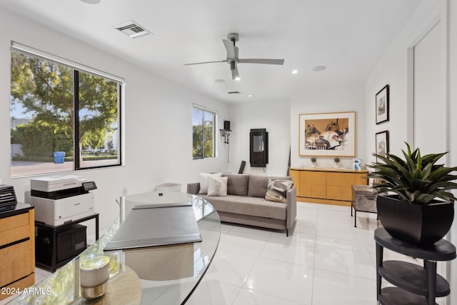 tiled living room featuring ceiling fan and plenty of natural light