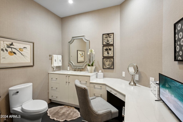 bathroom with toilet and vanity