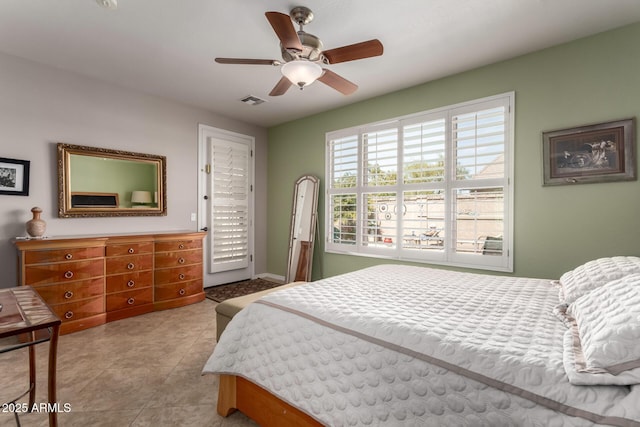 bedroom featuring tile patterned floors, visible vents, and a ceiling fan