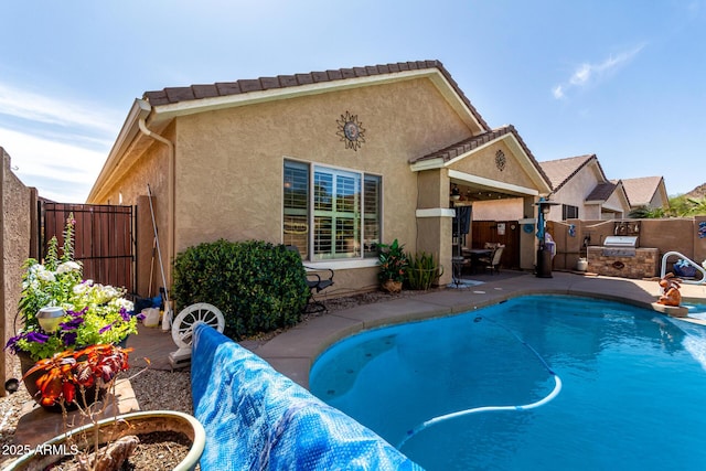 view of swimming pool featuring a patio, area for grilling, a fenced backyard, and a fenced in pool