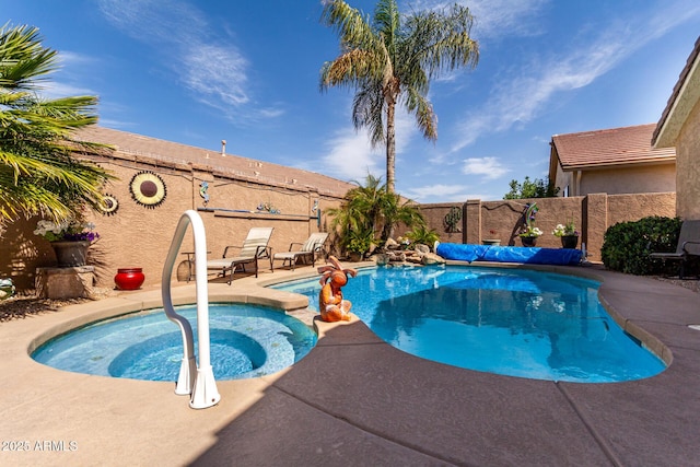 view of pool with a fenced in pool, an in ground hot tub, and a fenced backyard