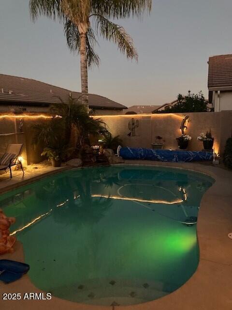 view of swimming pool with a fenced in pool and a fenced backyard