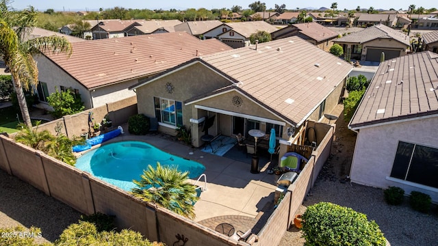 view of swimming pool with a patio area, a fenced in pool, a fenced backyard, and a residential view