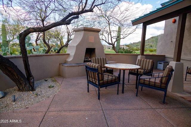 view of patio / terrace with exterior fireplace