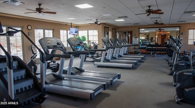 exercise room with visible vents and a paneled ceiling