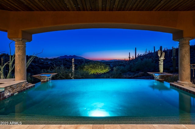 pool at dusk with a mountain view