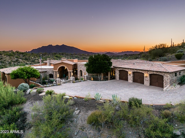 mediterranean / spanish-style house featuring a mountain view and a garage