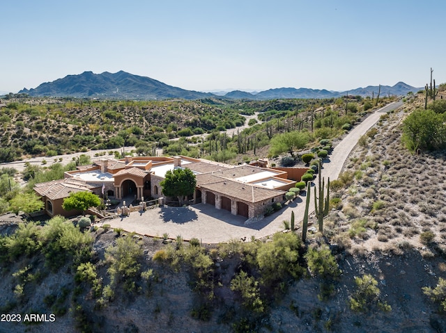 birds eye view of property with a mountain view