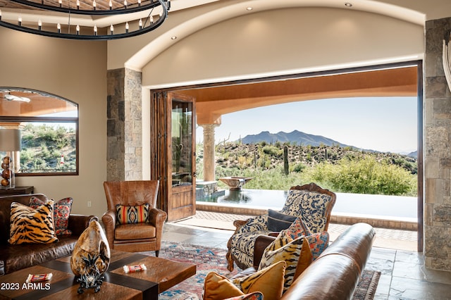 tiled living room featuring a mountain view and a towering ceiling