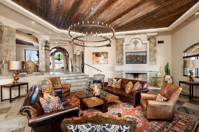 living room featuring an inviting chandelier, wood ceiling, decorative columns, and a fireplace